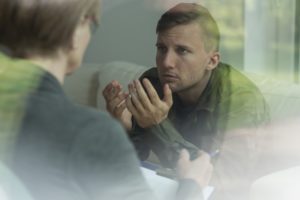 Young man is talking to therapist about his mental health 