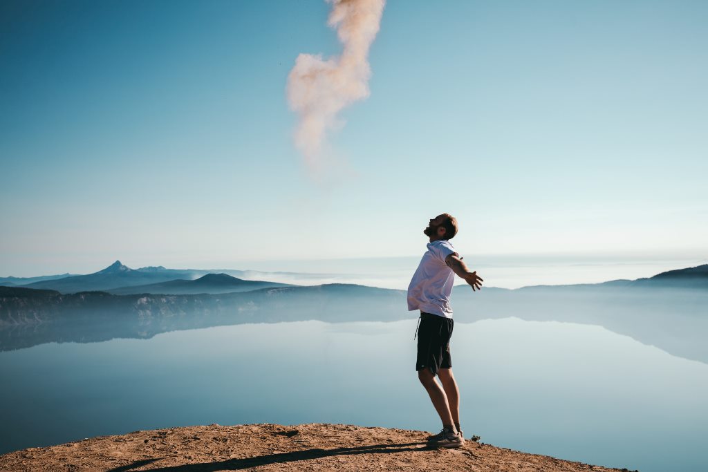 Cope with alcohol withdrawal - Happy sober man on top of a mountain