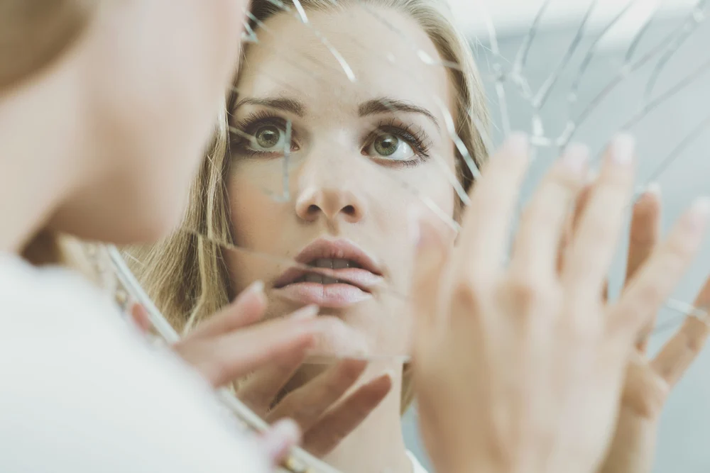 image of a woman breaking the glass ceiling to overcome addiction