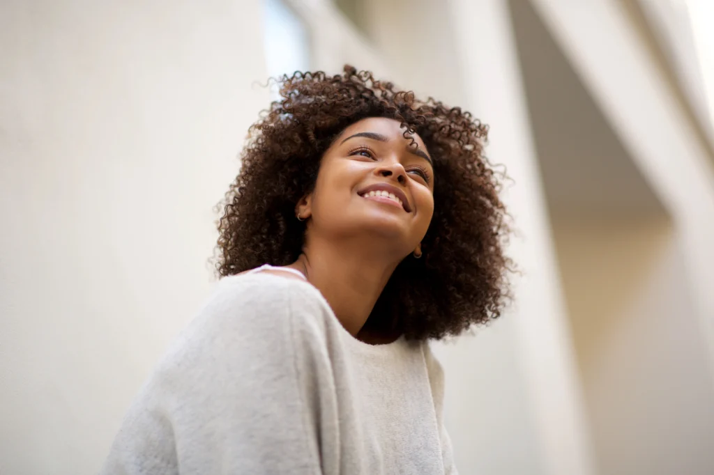 woman smiling after process addiction treatment for internet