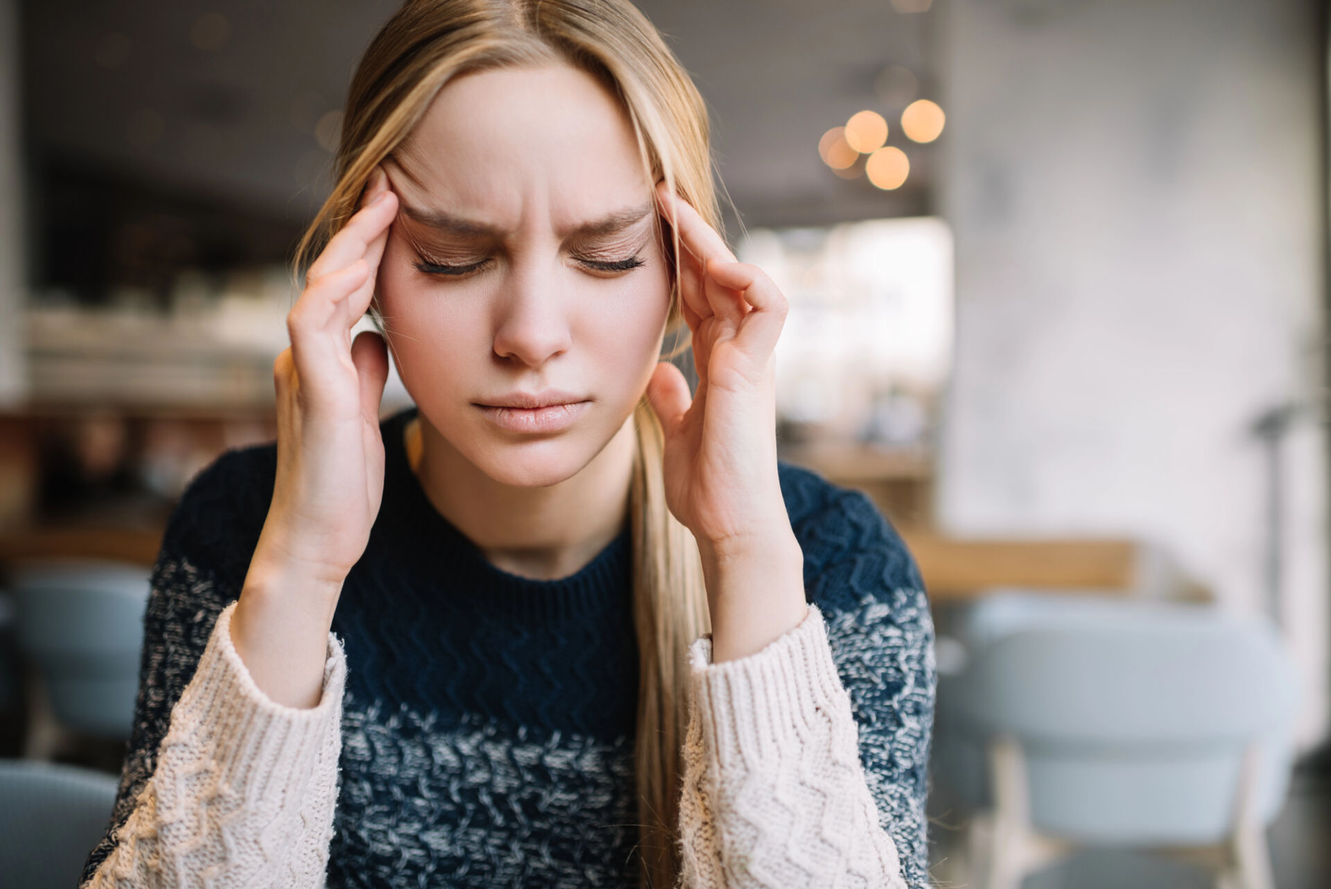 woman holding her temples representing that holiday stress is real