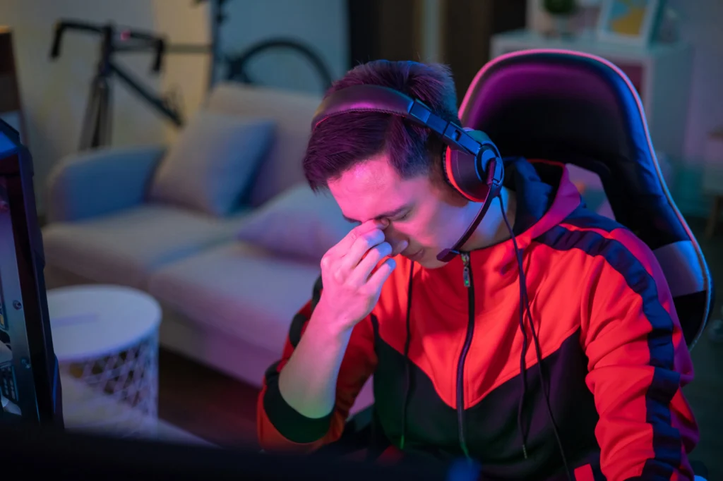 man looking stressed from gaming and internet addiction